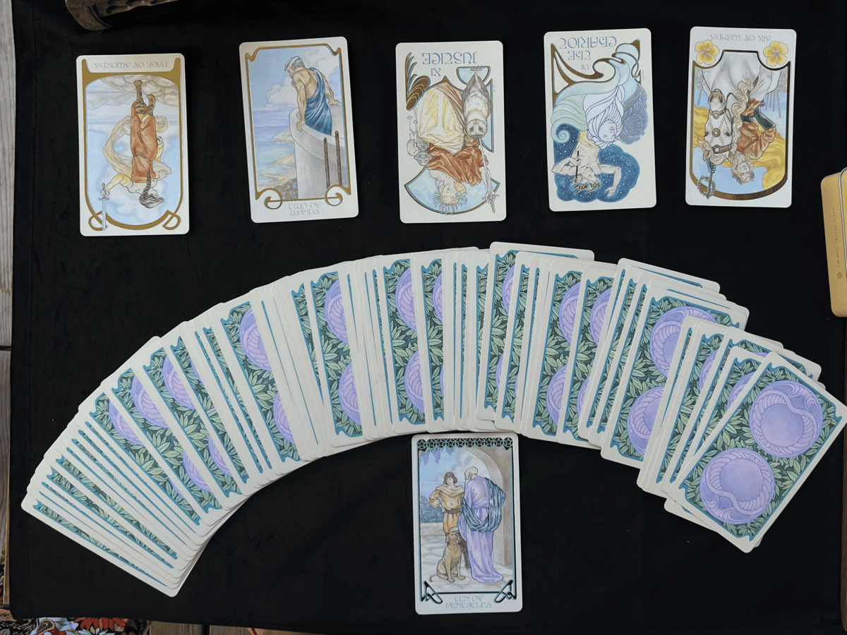 Mandy performing an in-person tarot reading with cards spread on a table